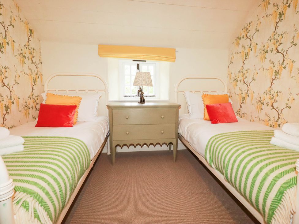 A bedroom with two beds and a nightstand at The Homestead