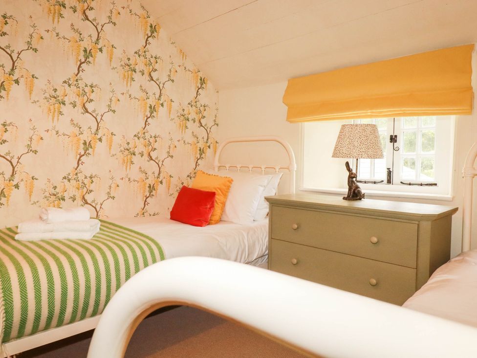 A bedroom with two beds and a dresser at The Homestead in 
