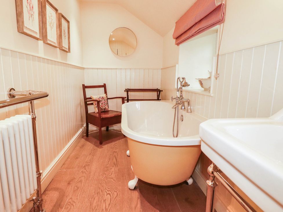 A bathroom with a bathtub and sink at The Homestead in 