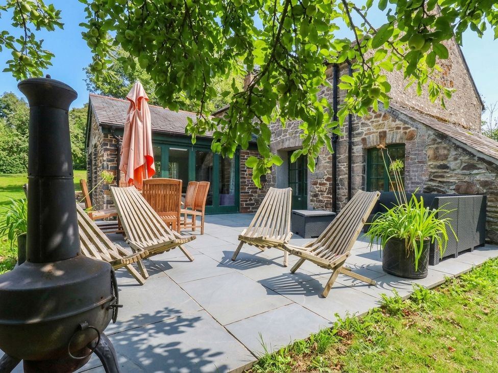 An outdoor patio with chairs and a table at The Homestead in 