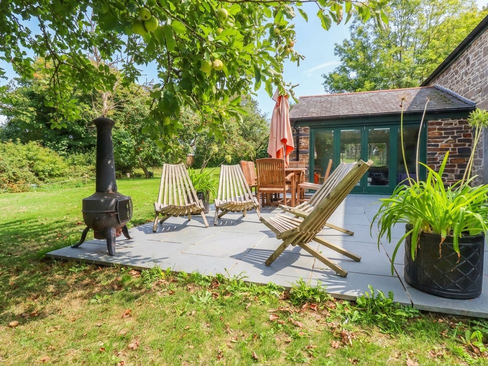 An outdoor seating area with chairs and table at The Homestead in 