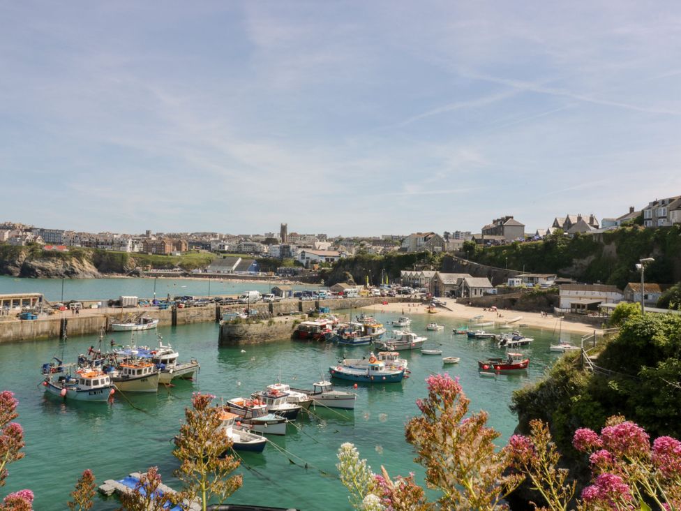 A view of boats docked at a harbor near a beach at The Homestead in Trerice near Newquay