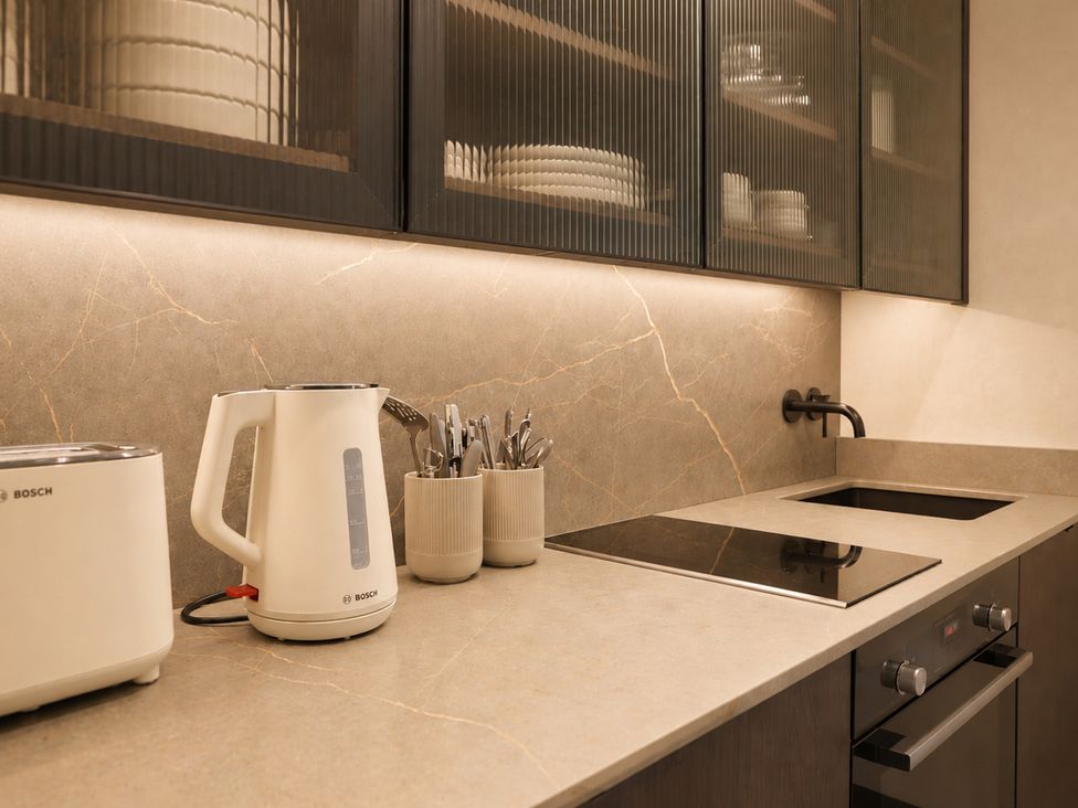 A kitchen with a kettle, toaster, and cutlery holder at The Hog Hut in Llanarth