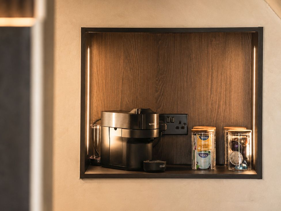 A coffee machine and tea supplies in a kitchen at The Hog Hut in Llanarth