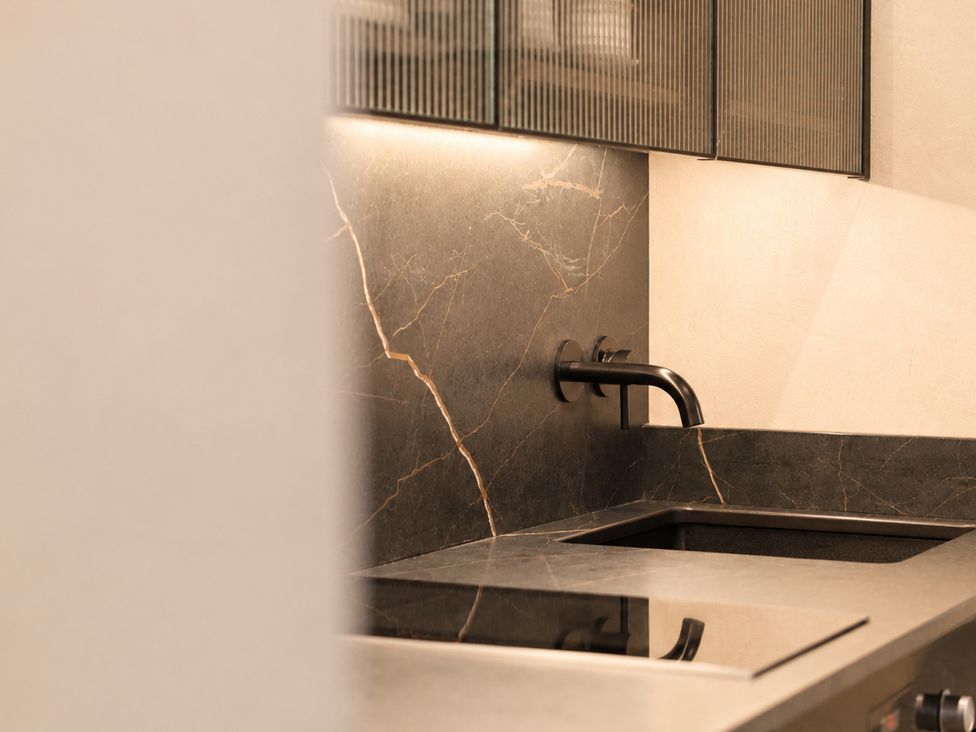 A kitchen featuring a sink and stovetop at The Hog Hut in Llanarth