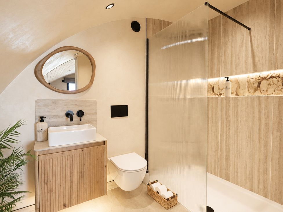 A bathroom with a sink, toilet, and shower at The Hog Hut in Llanarth