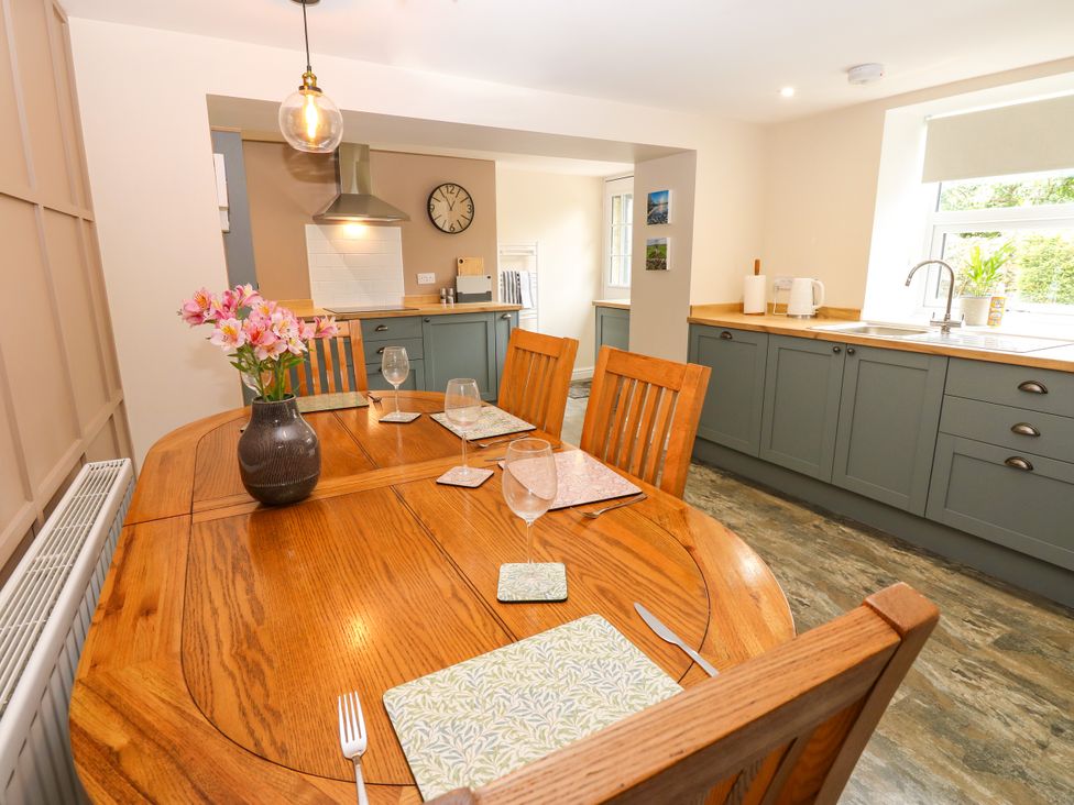 A dining room with a wooden table and chairs at Woody Bank
