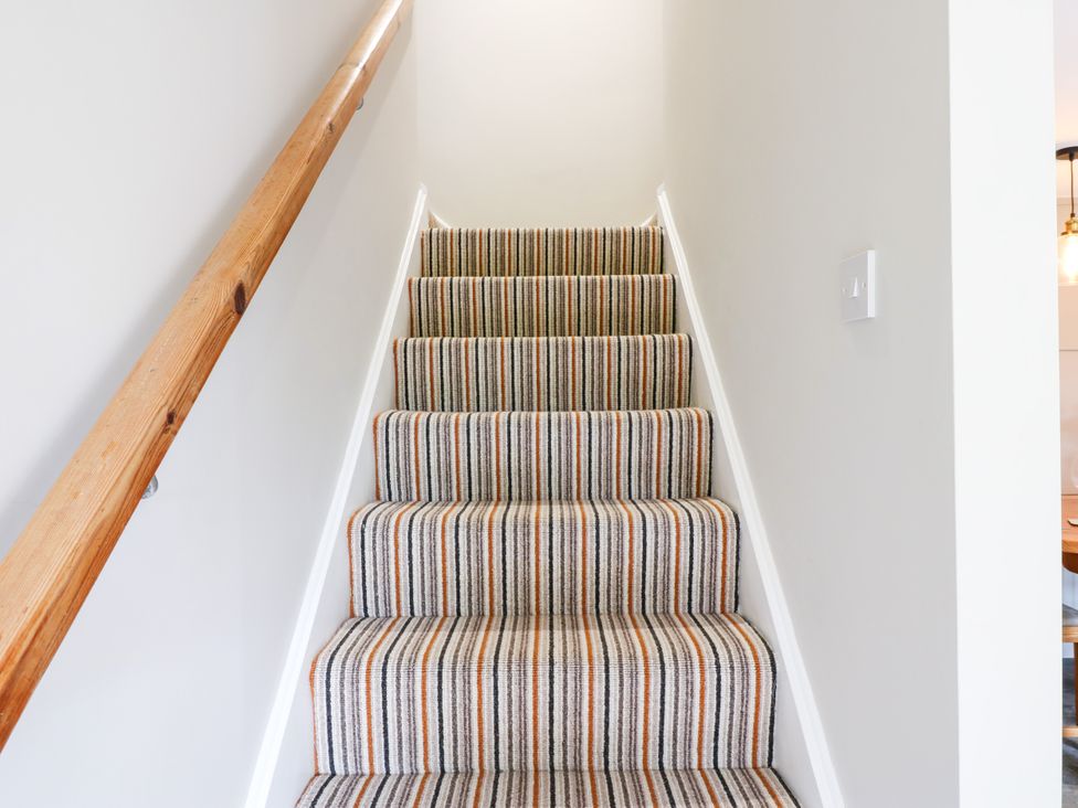 A staircase with striped carpet at Woody Bank