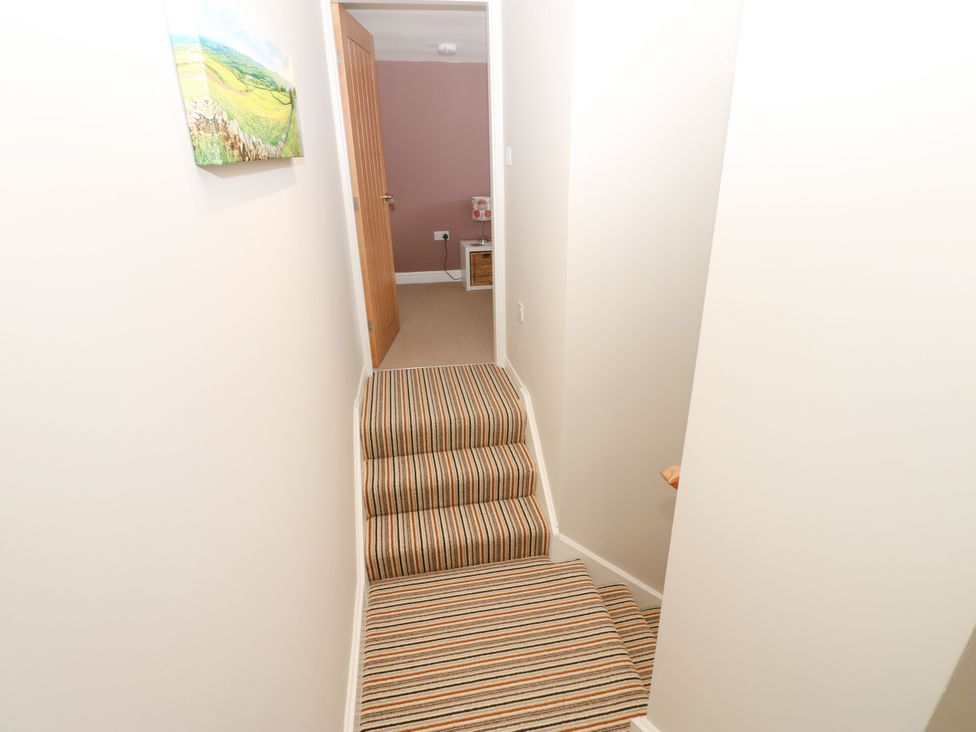 A hallway with stairs leading down at Woody Bank