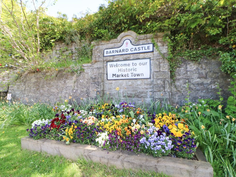 A welcome sign with flowers at Barnard Castle