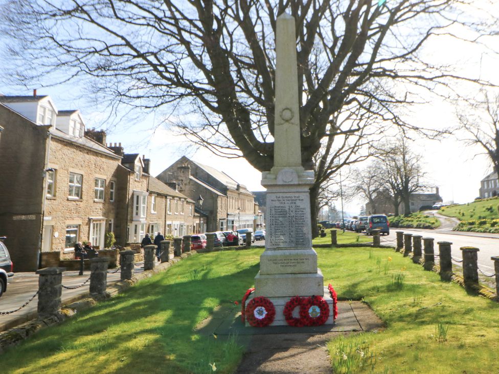 A monument surrounded by buildings and a road at Woody Bank