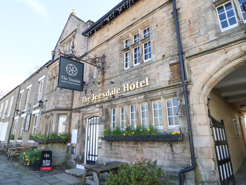 The exterior of The Teesdale Hotel with signage and plants at Woody Bank