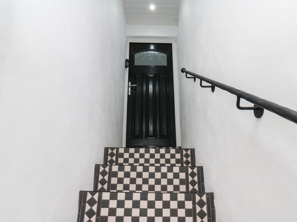 A staircase leading to a door at 14 Brunswick Street Whitby