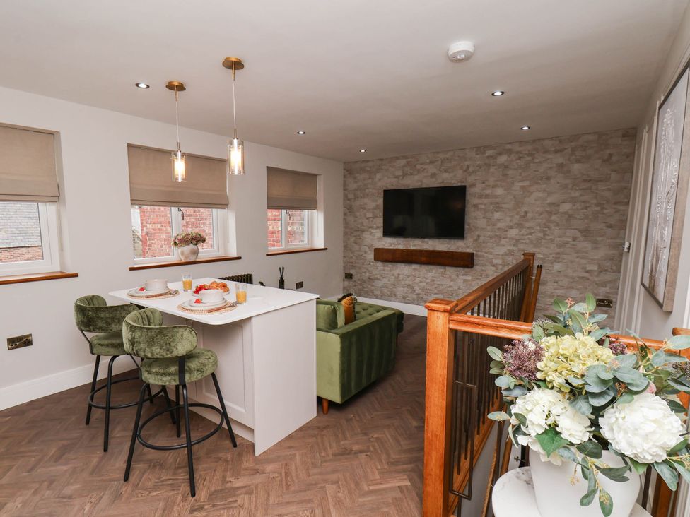 A living room with a sofa and table at 14 Brunswick Street, Whitby
