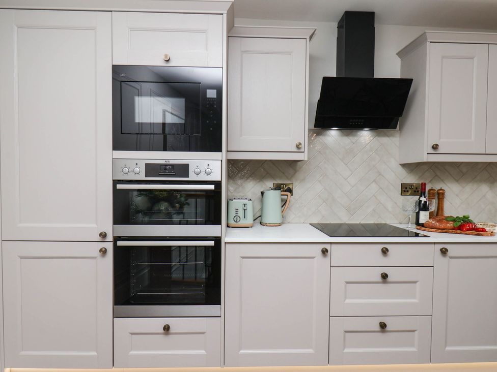 A kitchen with built-in appliances and countertop at 14 Brunswick Street Whitby