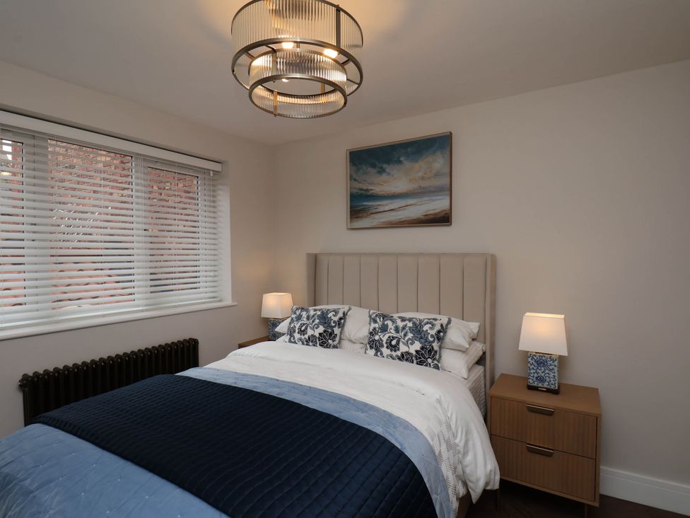 A bedroom with a bed, bedside table, and window at 14 Brunswick Street Whitby