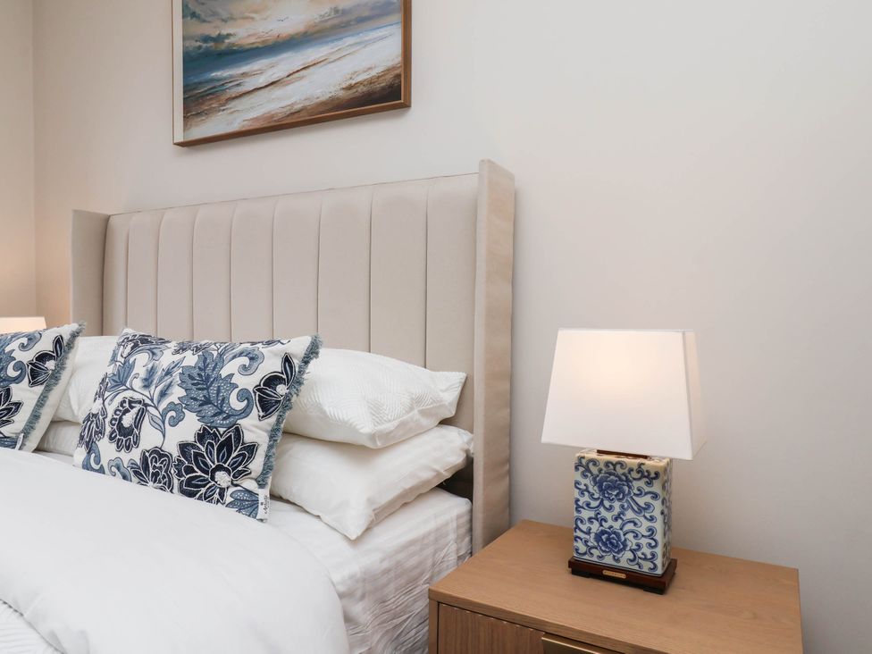 A bedroom with a bed and lamp at 14 Brunswick Street Whitby