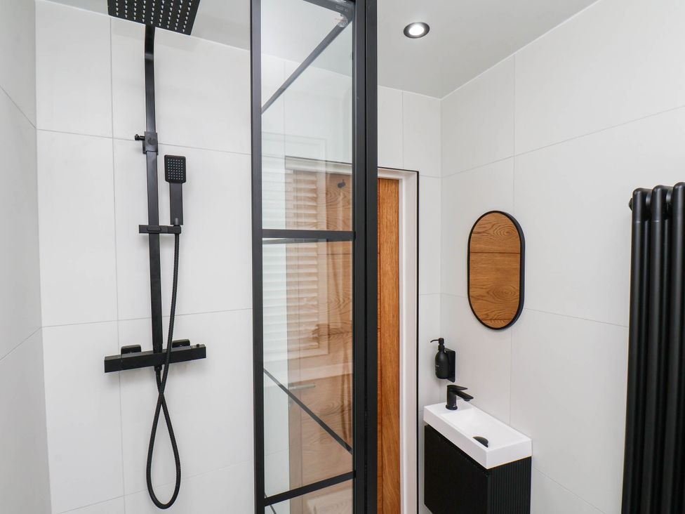 A bathroom with a shower and sink at 14 Brunswick Street Whitby