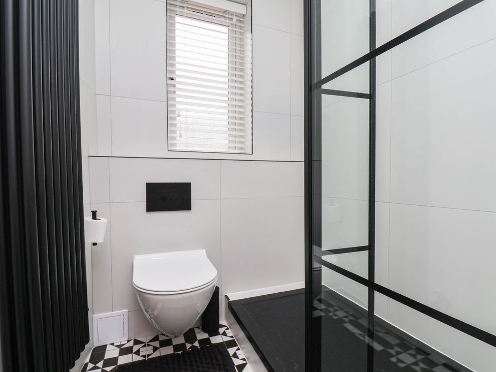 A bathroom with a toilet and shower at 14 Brunswick Street in Whitby