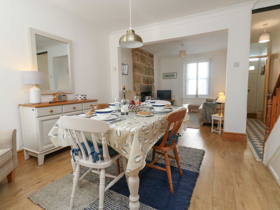 A dining room with a table set for a meal at 57 High Street in Portland