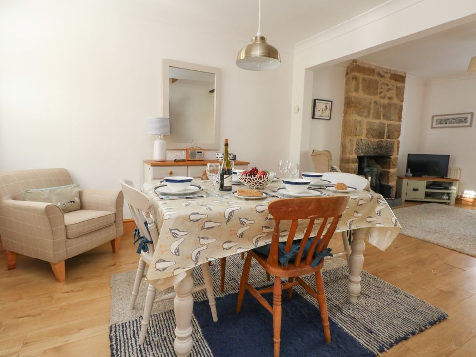 A dining room with a table set for a meal at 57 High Street in Portland