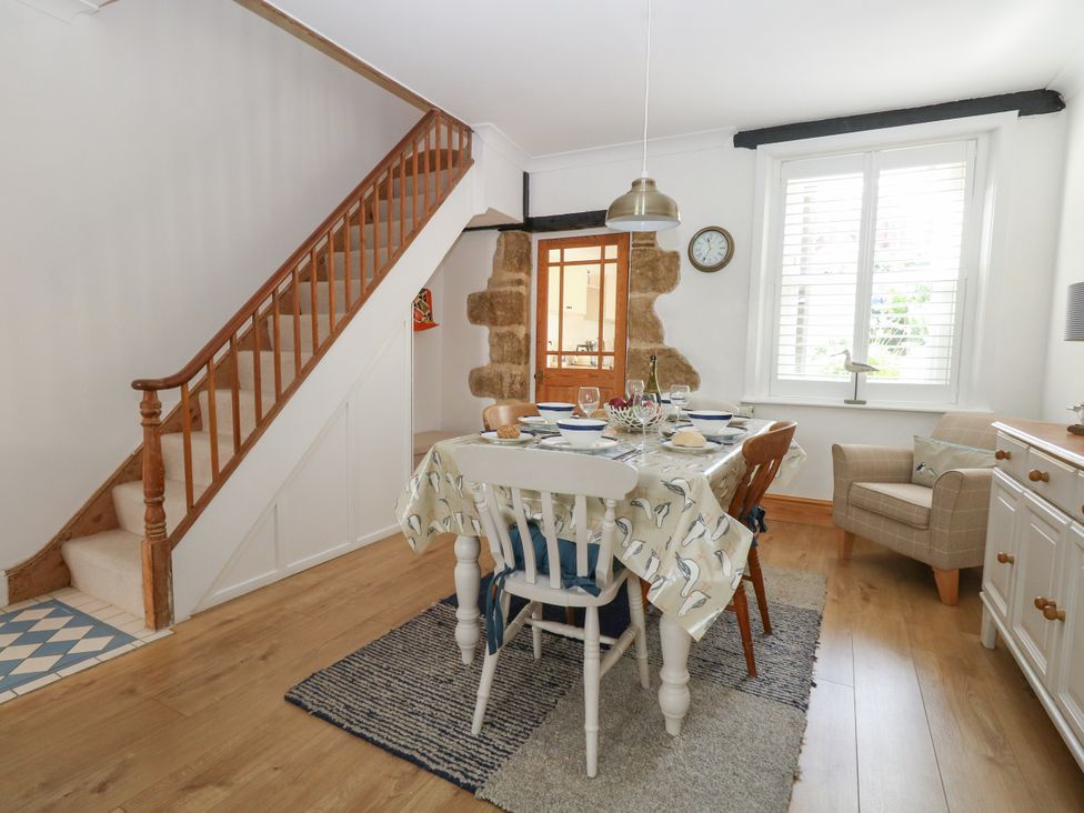 A dining room with a table and chairs at 57 High Street in Portland