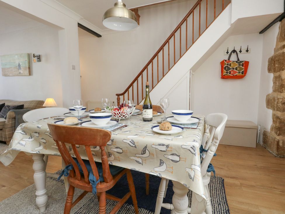 A dining room with a table set for a meal at 57 High Street in Portland