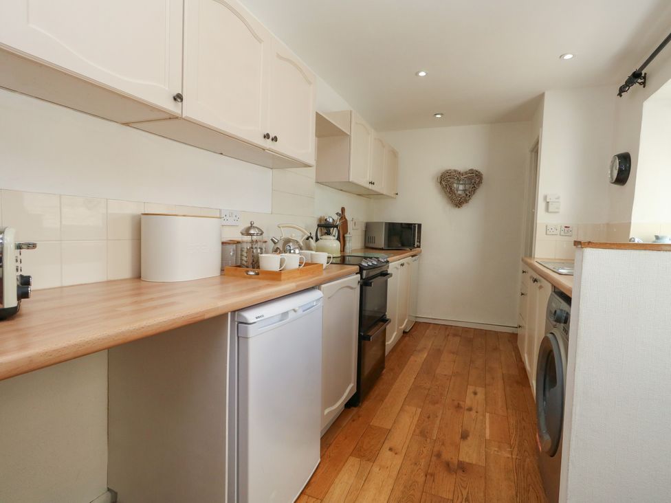 A kitchen with cabinets and appliances at 57 High Street Portland