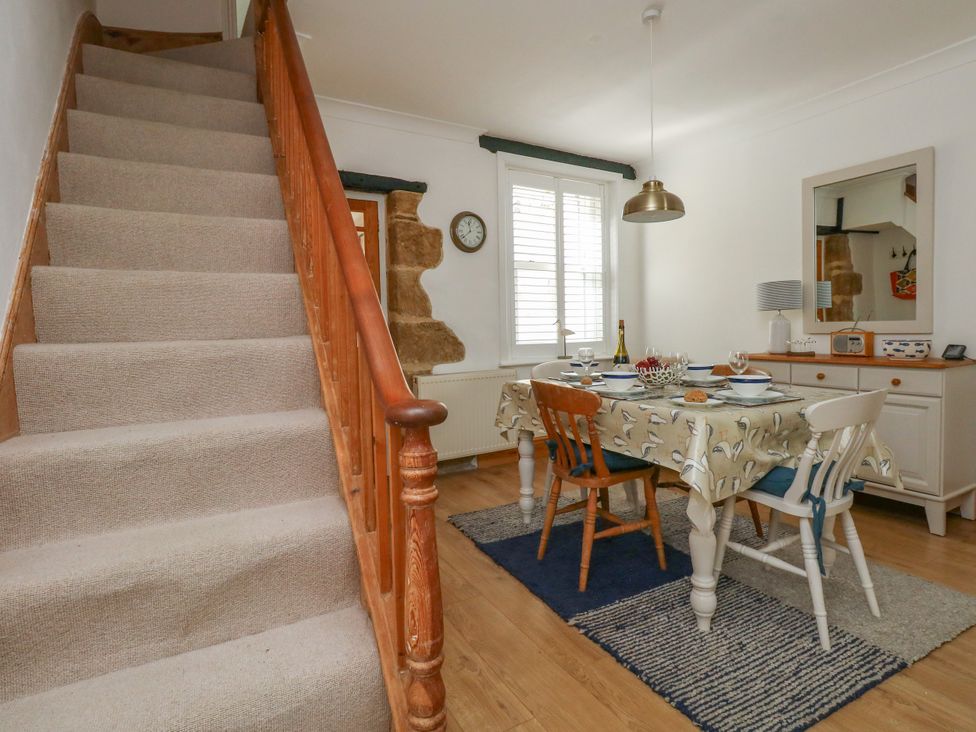 A dining room with a table set for a meal at 57 High Street in Portland