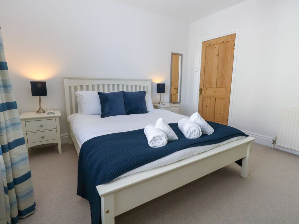A bedroom with a bed and bedside table at 57 High Street in Portland
