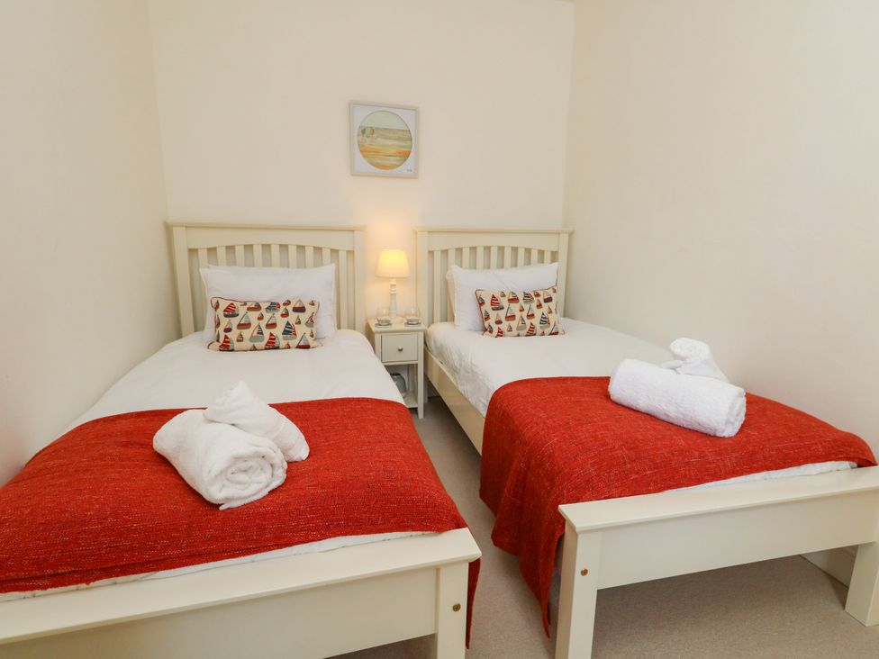 A bedroom with two beds and a bedside table at 57 High Street in Portland