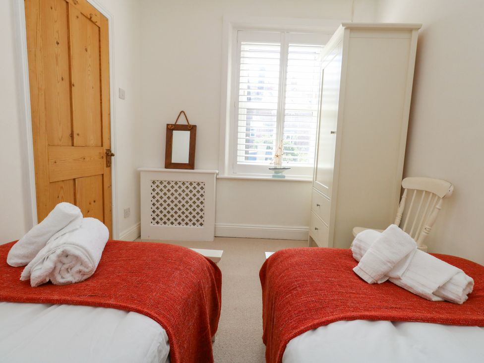 A bedroom with two beds and a wardrobe at 57 High Street, Portland