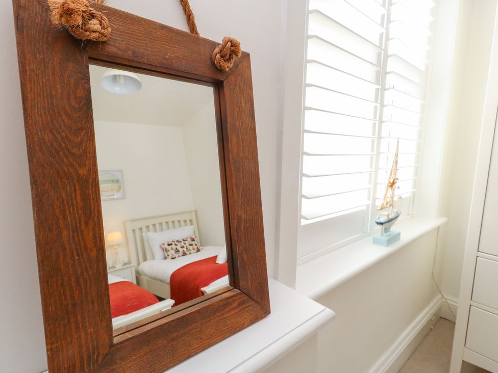 A bedroom with a bed and decorative items at 57 High Street in Portland
