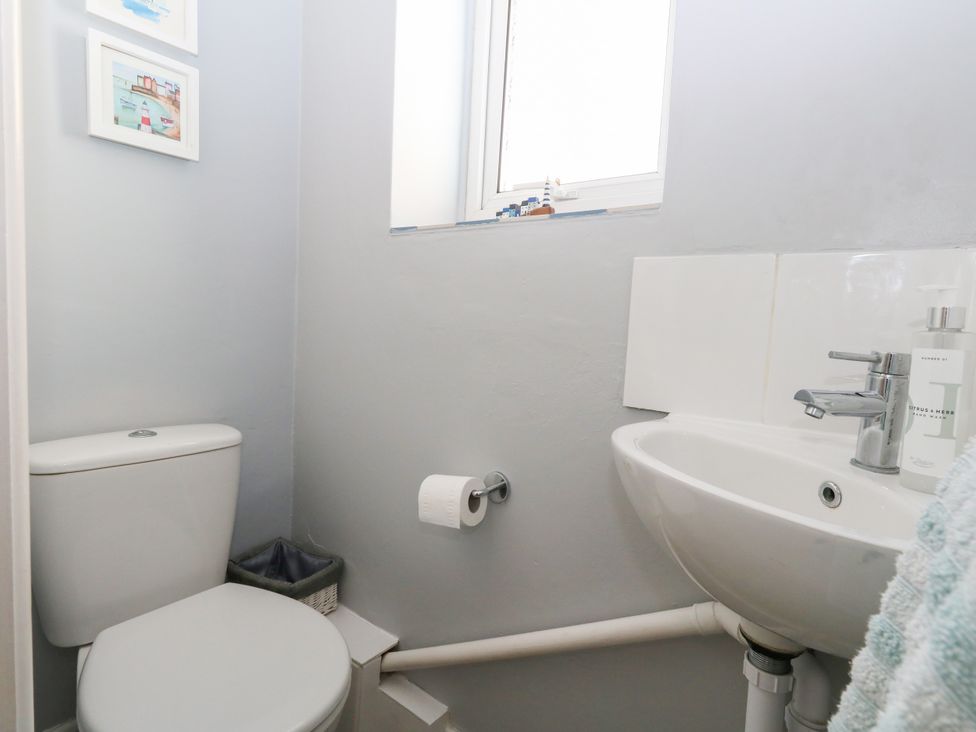 A bathroom with a toilet and sink at 57 High Street in Portland