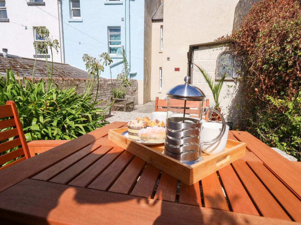 An outdoor table with a french press and pastries at 57 High Street Portland