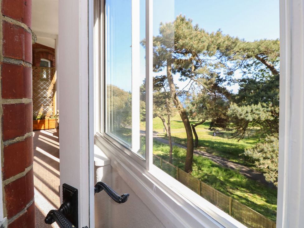A view of trees and a pathway from a window at The Pines in Bournemouth