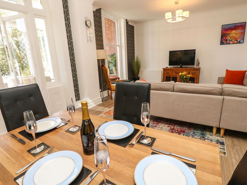 A dining room with a table set for dinner at The Pines Bournemouth