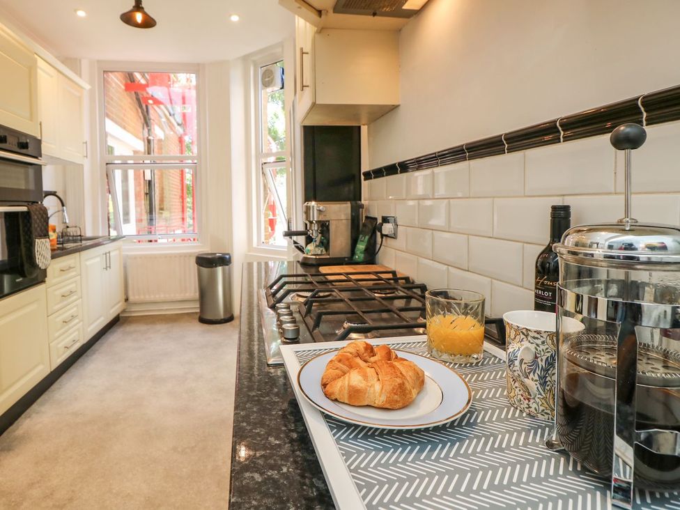 A kitchen with a stove and croissant on the countertop at The Pines in Bournemouth