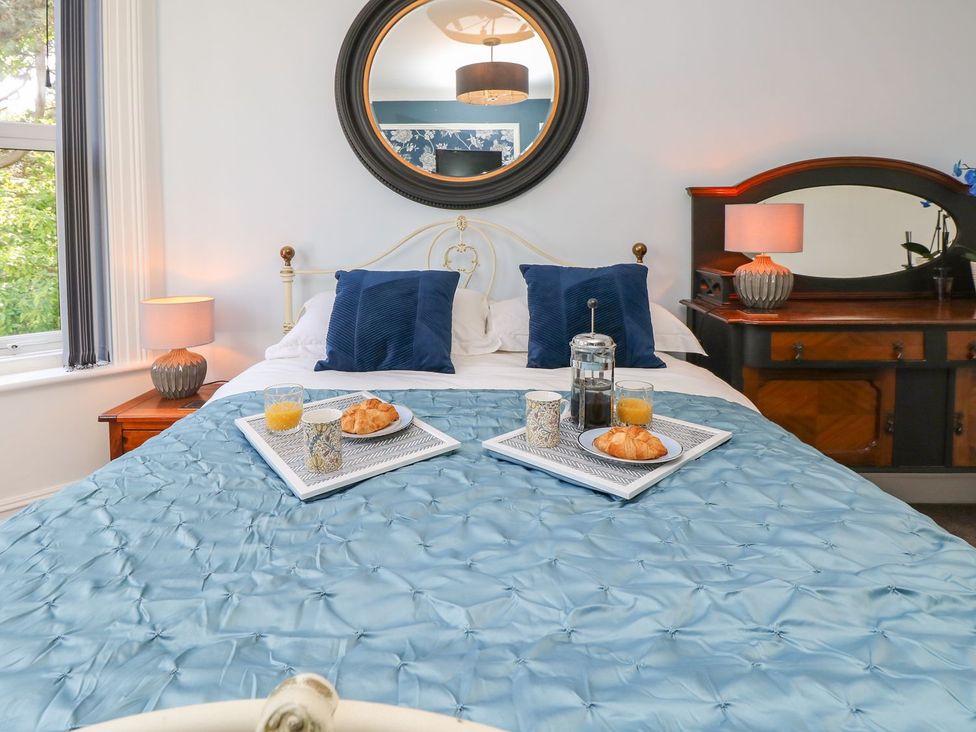 A bedroom with a bed and breakfast tray at The Pines in Bournemouth