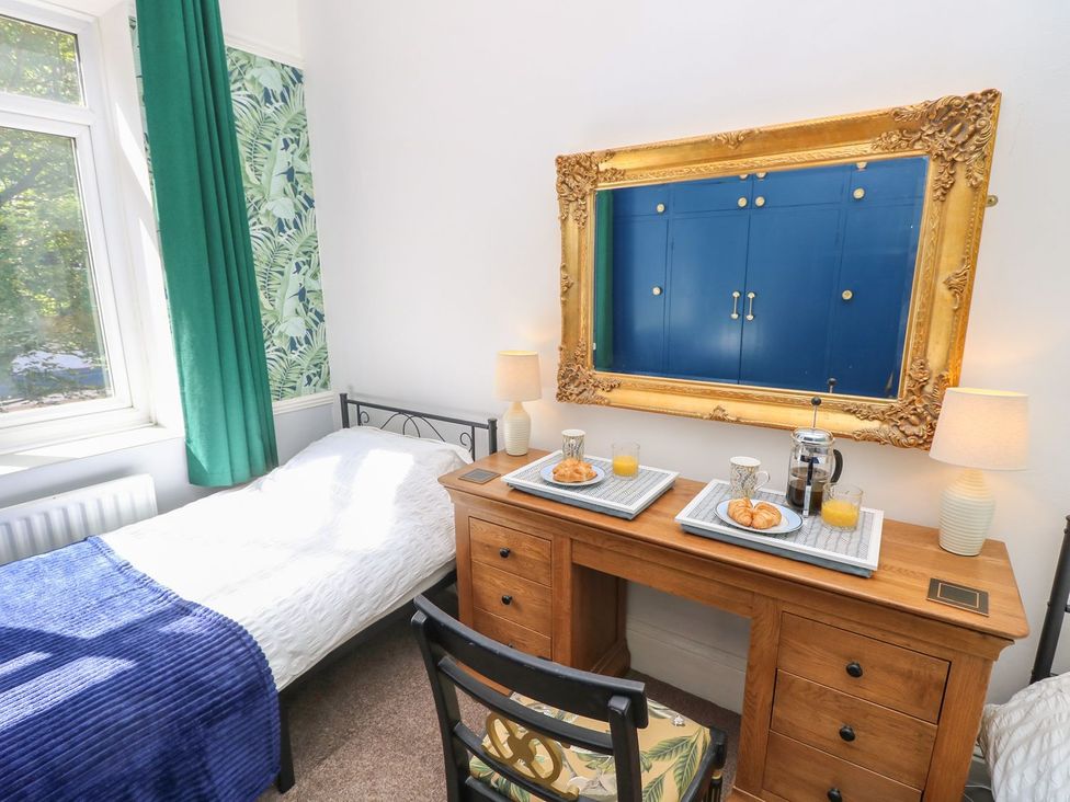 A bedroom with a bed and a table serving breakfast at The Pines in Bournemouth