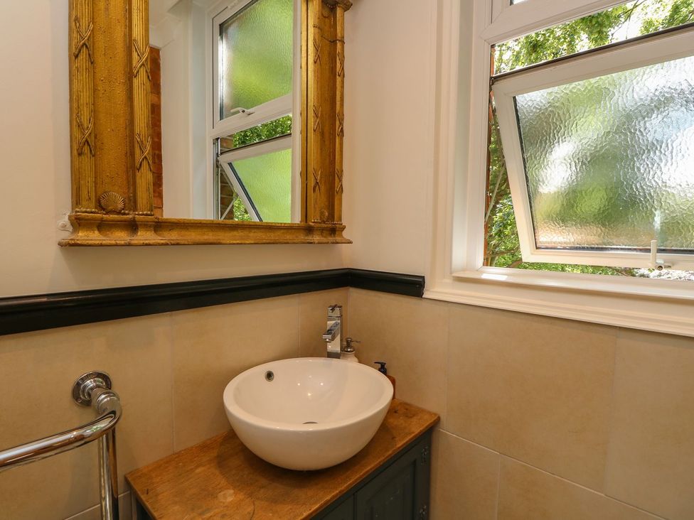 A bathroom with a sink and mirror at The Pines in Bournemouth