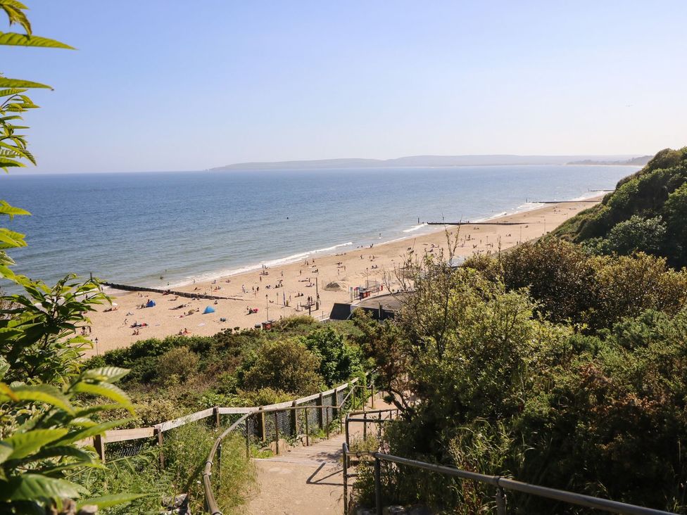 A view of the beach with people enjoying at The Pines in Bournemouth