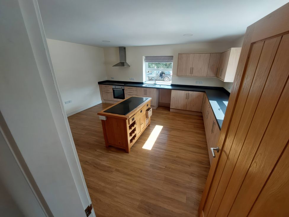 A kitchen with cabinets and an island at Wold View in Market Rasen