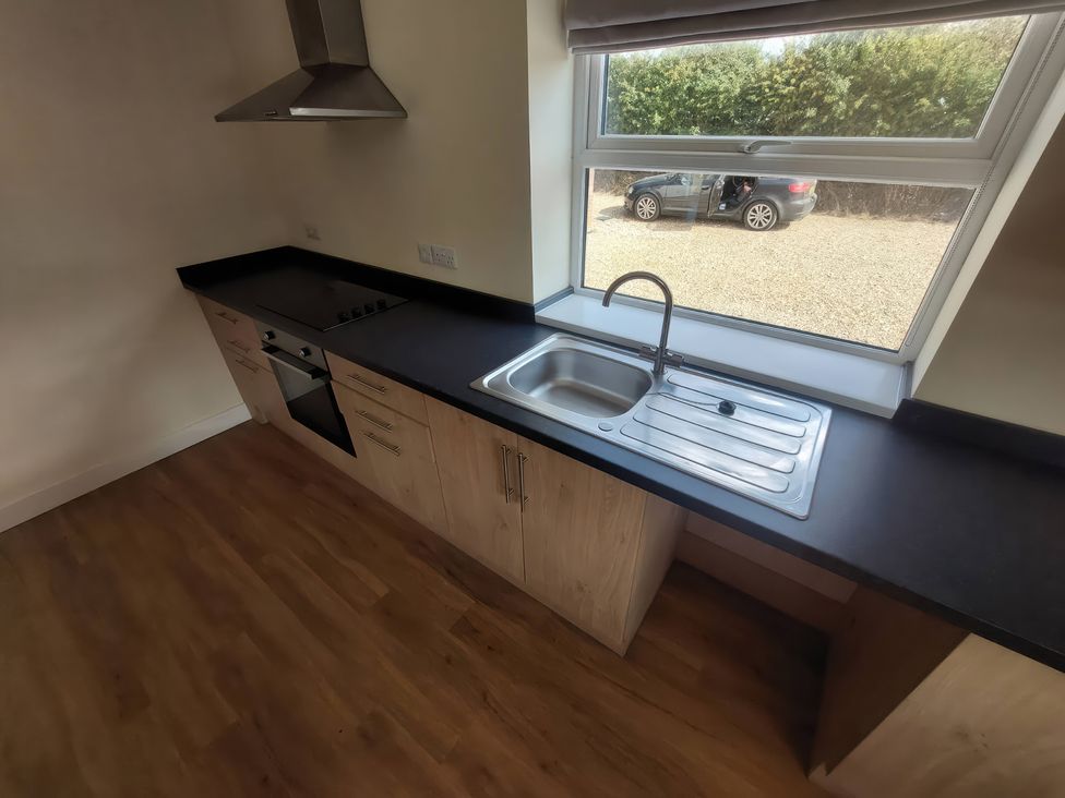 A kitchen with a sink and stove at Wold View in Market Rasen