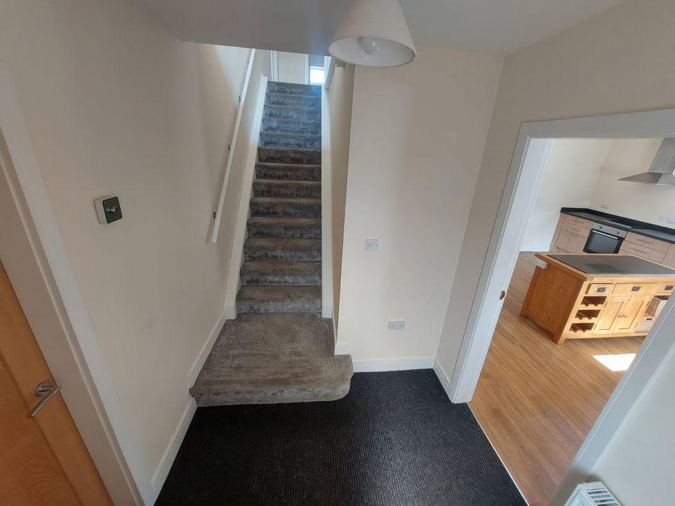 A hallway with stairs leading to an upper floor at Wold View in Market Rasen