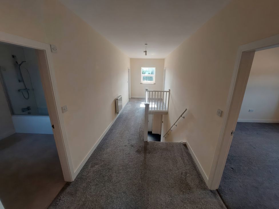 A hallway with staircase and doors at Wold View in Market Rasen