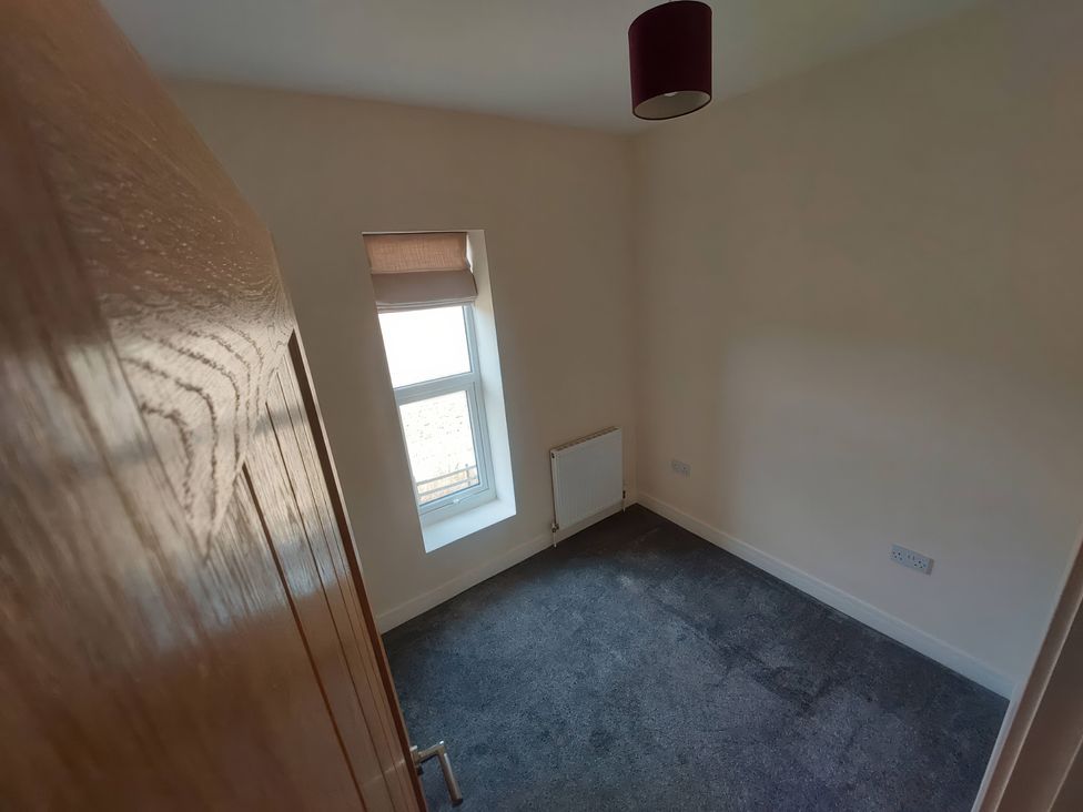 A bedroom with a window and radiator at Wold View in Market Rasen