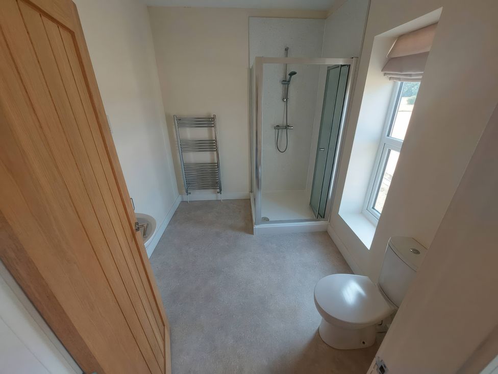 A bathroom with a shower and toilet at Wold View in Market Rasen