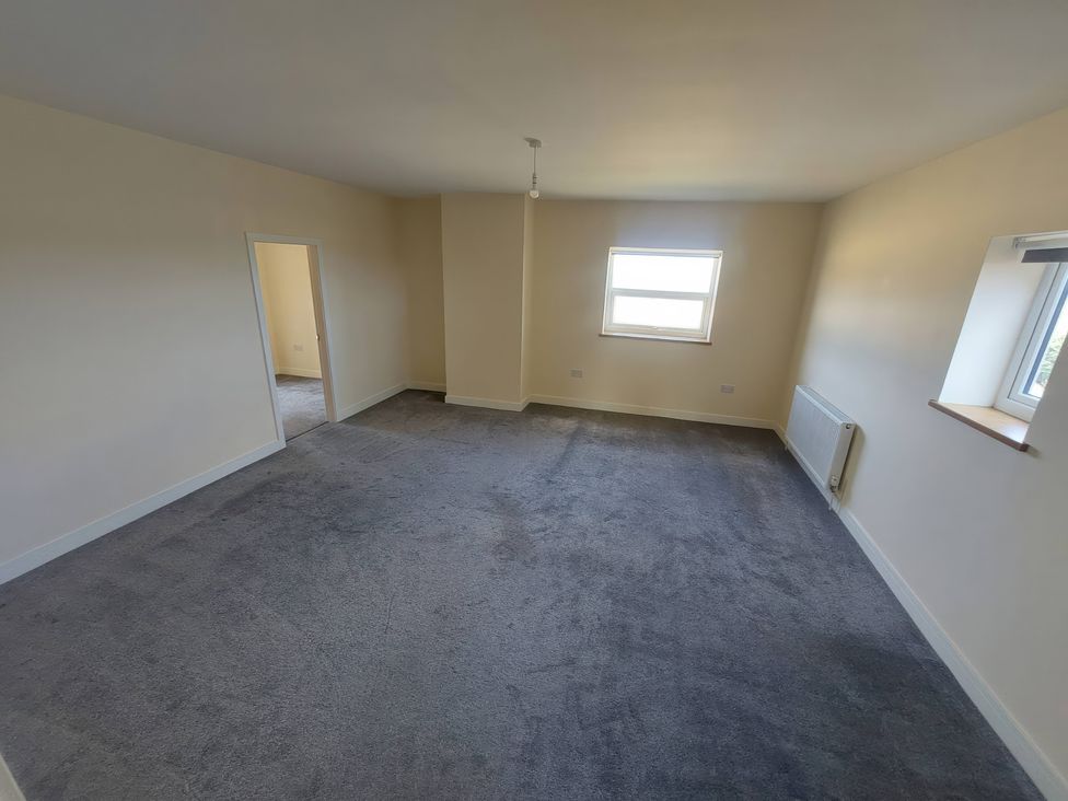 A living room with a window and door at Wold View in Market Rasen