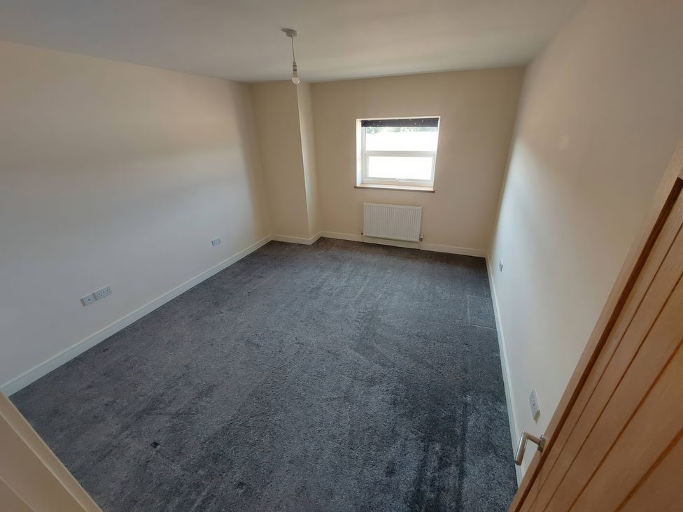 A bedroom with window and radiator at Wold View in Market Rasen